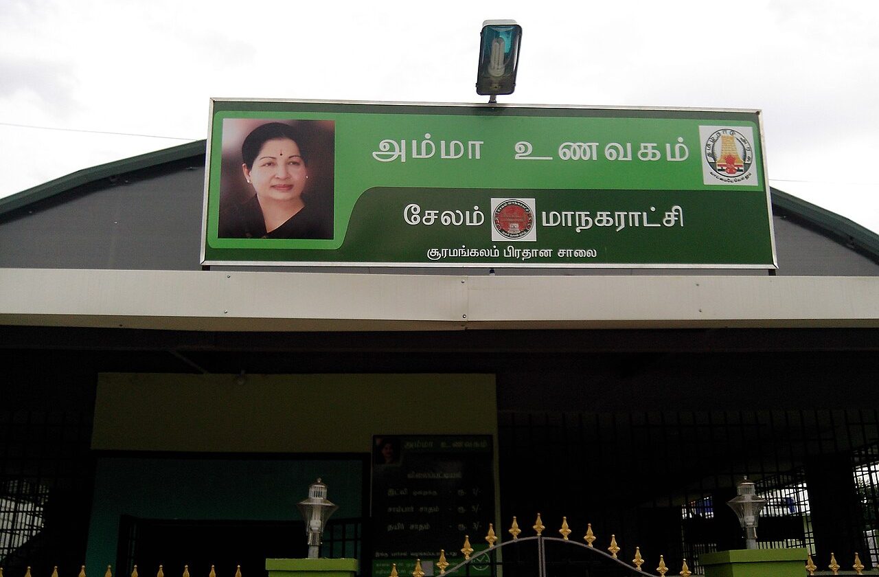 A canteen in Salem, Tamil Nadu, with a large green sign reading Amma Unavagam in Tamil beside a portrait of Jayalalithaa